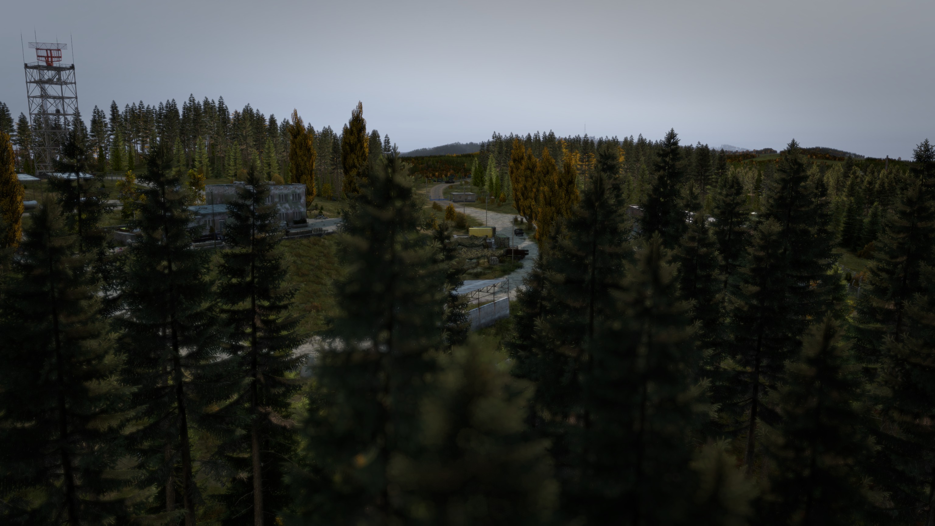 Radio tower rising above a forested ridge